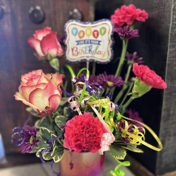 Birthday bouquet with pink roses and carnations in a glass vase