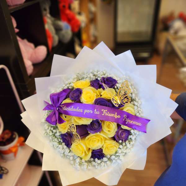 Bouquet of yellow and purple roses with a ribbon and butterfly decorations