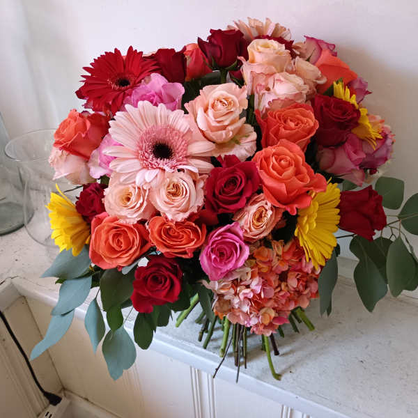 Mixed bouquet of roses, gerbera daisies, and hydrangea in bright colors