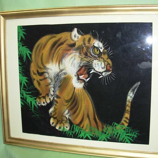 Framed painting of a tiger on a black background