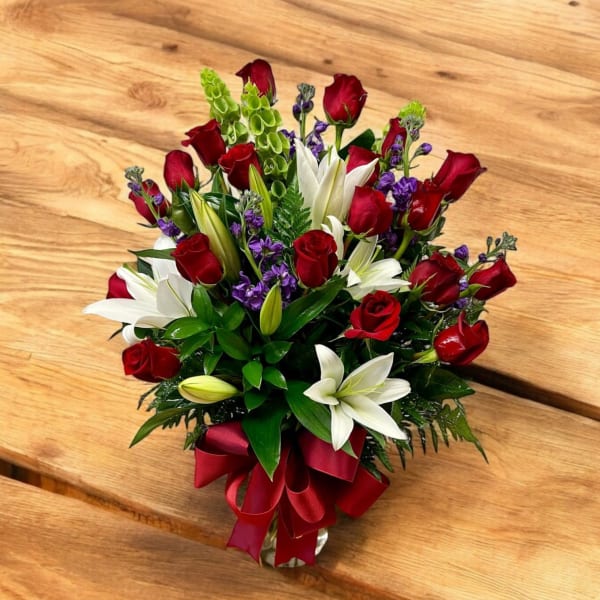 Bouquet of red roses and white lilies with a red ribbon