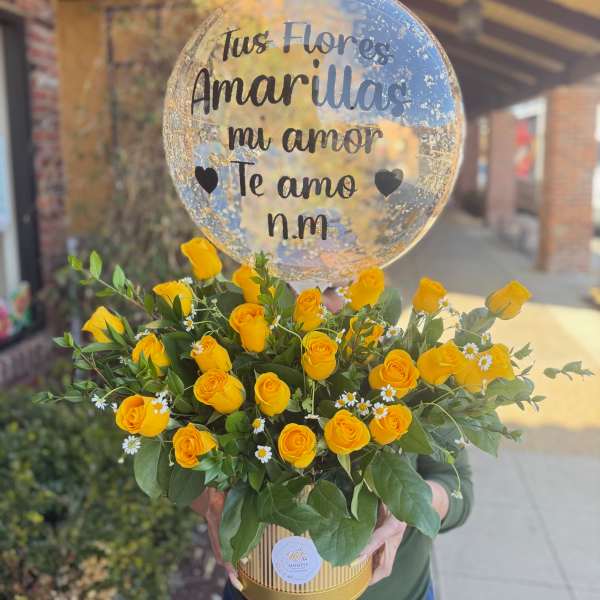 Yellow roses in a gold box with a clear heart balloon