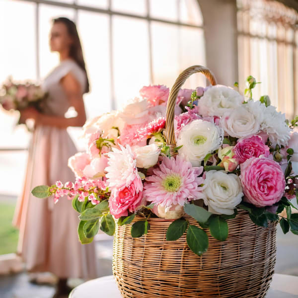 Pink and white flower basket with a wicker handle