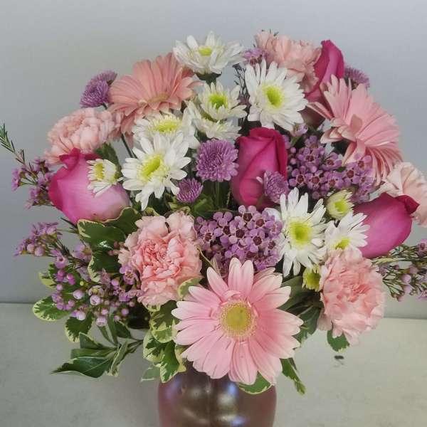 Pink and white mixed bouquet in a brown vase