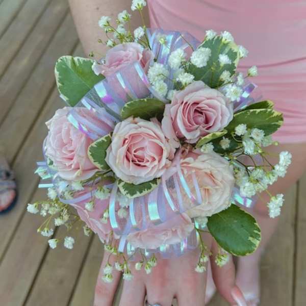 Handheld bouquet of pale pink roses with baby's breath and ribbon
