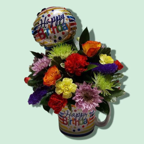 Birthday flower arrangement in a mug with a balloon