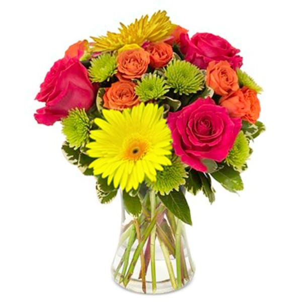 Bouquet of pink and orange roses with yellow gerbera daisies in a glass vase