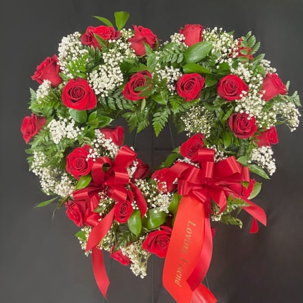 Heart-shaped red rose wreath with white baby's breath and red ribbons