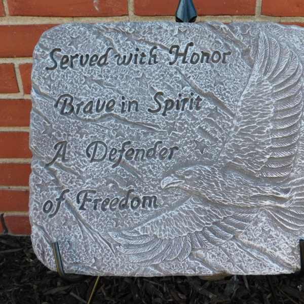 Memorial stone plaque with an eagle relief and engraved text