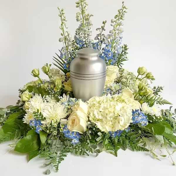 White and blue floral urn arrangement with a silver urn centerpiece