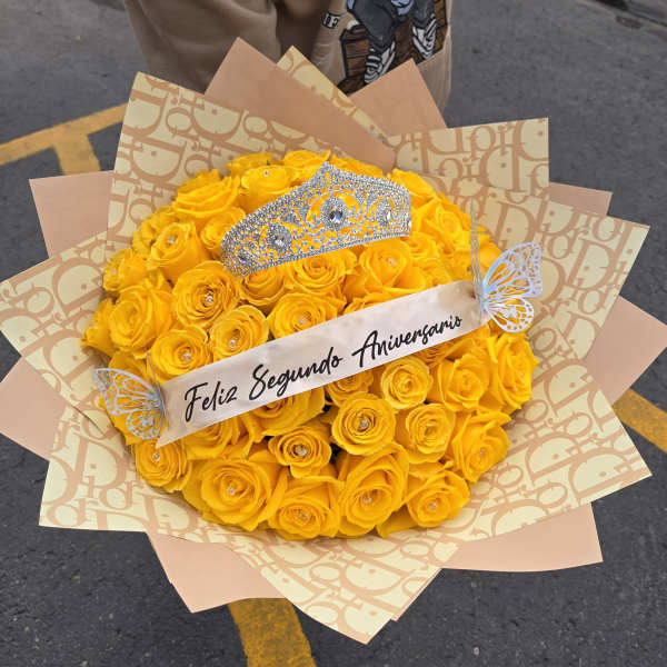 Yellow rose bouquet with a jeweled tiara and anniversary ribbon