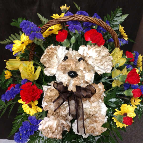 Teddy bear made of flowers in a basket with colorful blooms