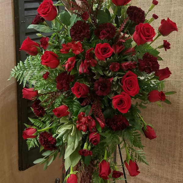 Tall red rose and burgundy floral standing arrangement on an easel