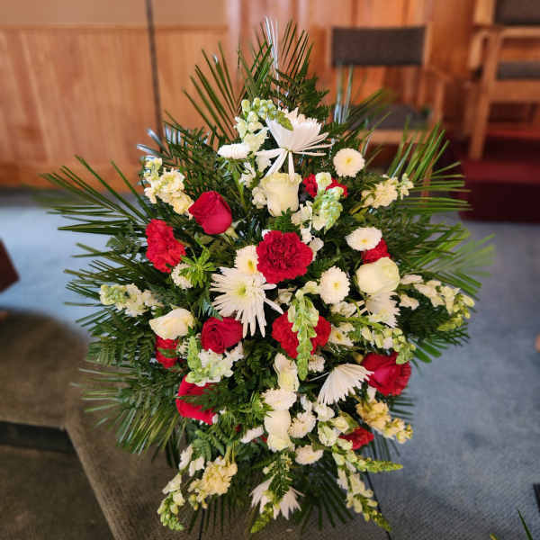 Standing floral spray with red and white flowers and palm fronds
