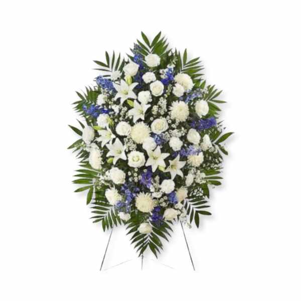 Standing floral spray of white and blue flowers on an easel