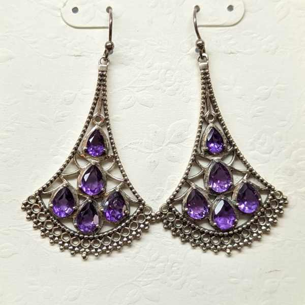 Pair of silver chandelier earrings with purple teardrop stones