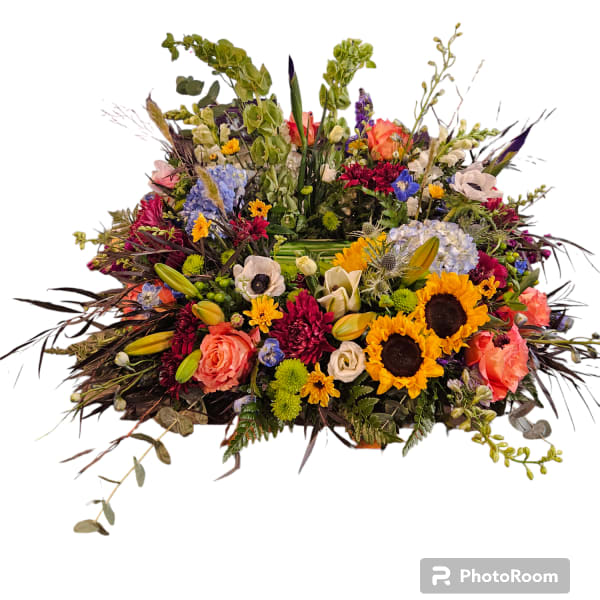 Large mixed flower arrangement with sunflowers, roses, and lilies