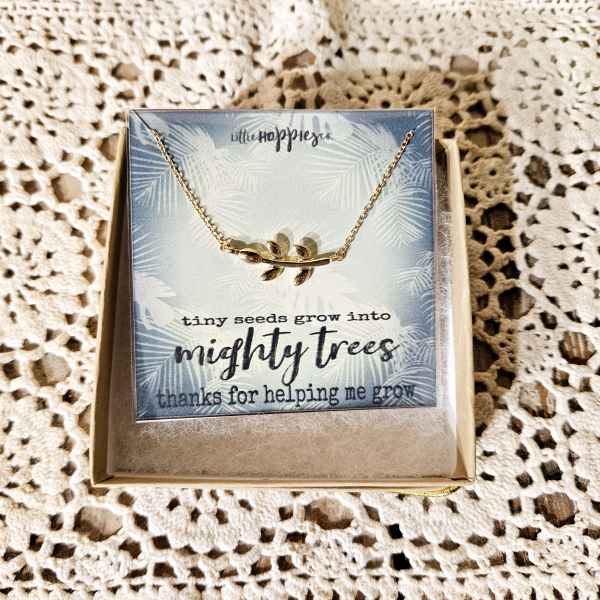 Gold necklace on a greeting card in a gift box