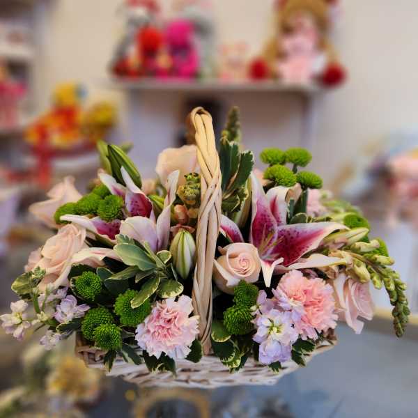 Basket of pink and white flowers with green button mums