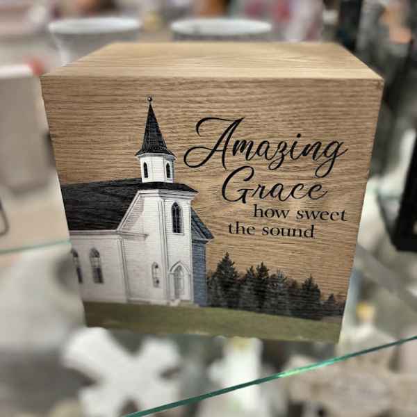 Wooden box with a church illustration and the words "Amazing Grace"