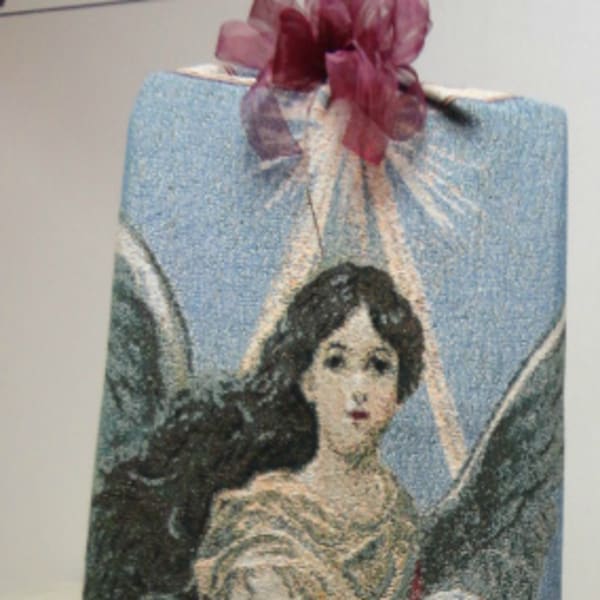 Decorative gift bag with an angel illustration and ribbon bow