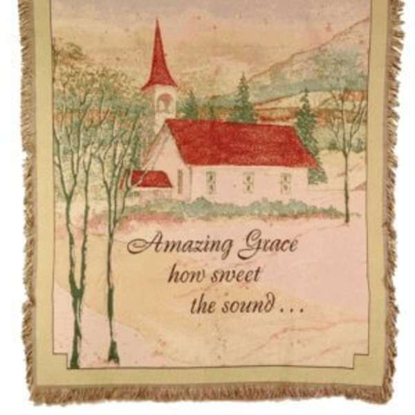 Framed wall hanging with a church scene and the words Amazing Grace