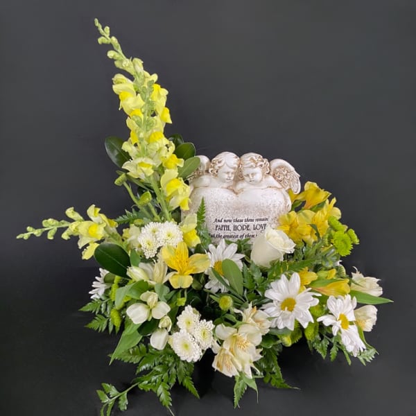 Yellow and white floral arrangement with an angel heart plaque