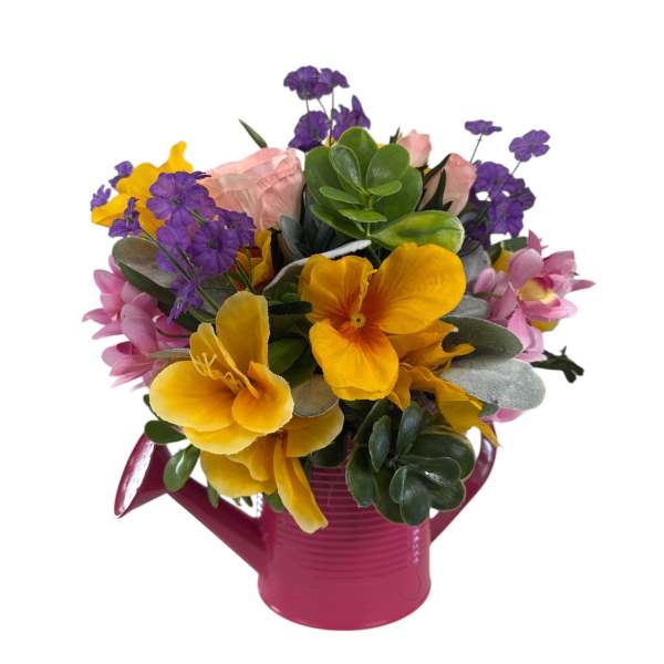 Bright mixed bouquet in a pink watering can