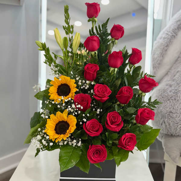 Red roses and yellow sunflowers in a black box arrangement