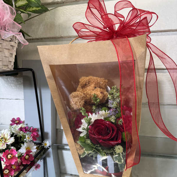 Wrapped bouquet with a teddy bear and red rose