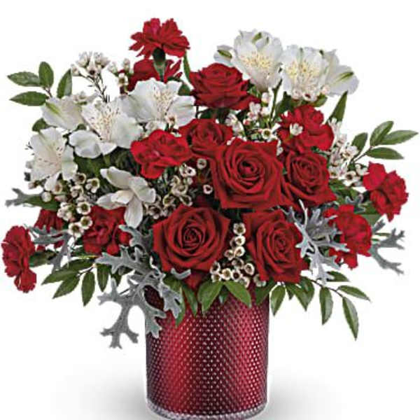 Red roses and white alstroemeria in a red vase
