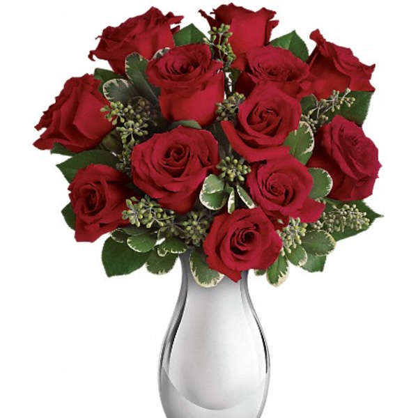 Red roses arranged in a silver vase