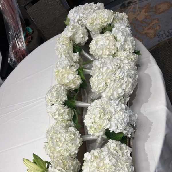 White floral garland with clustered blooms and a few lily buds