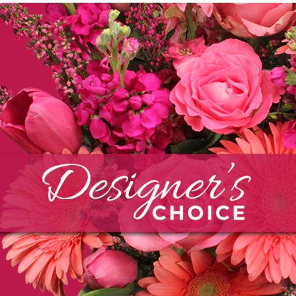 Pink floral arrangement with roses and daisies labeled Designer's Choice