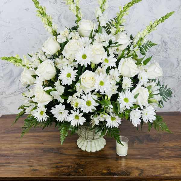 White roses and daisies in a low vase arrangement