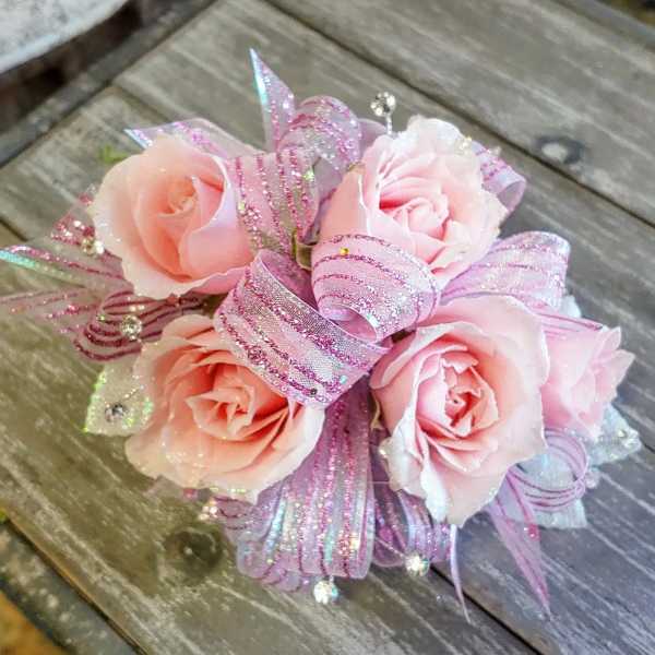 Small bouquet of pale pink roses with glittery pink ribbon