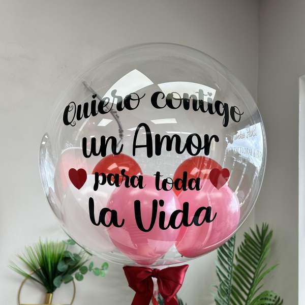 Clear balloon with pink balloons and Spanish love message