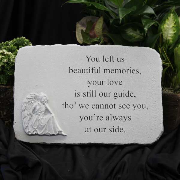 Memorial stone with an angel relief and engraved sympathy message