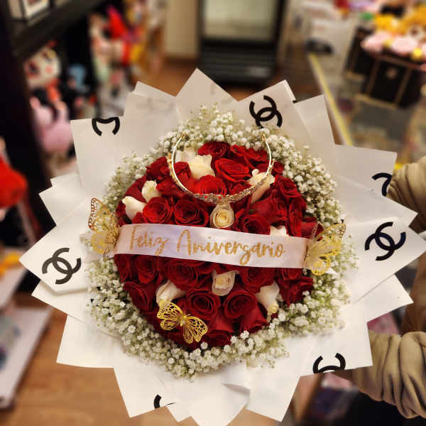 Bouquet of red and white roses with baby's breath and decorative wrap
