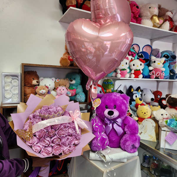 Pink rose bouquet with a heart balloon and purple teddy bear