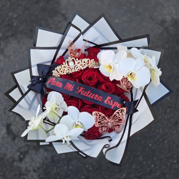 Bouquet of red roses and white orchids with decorative butterflies and ribbon