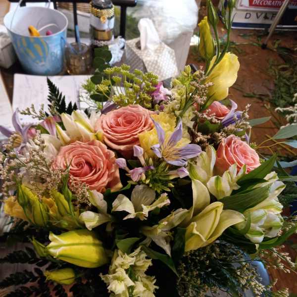 Mixed bouquet with pink roses, yellow lilies, and lavender flowers