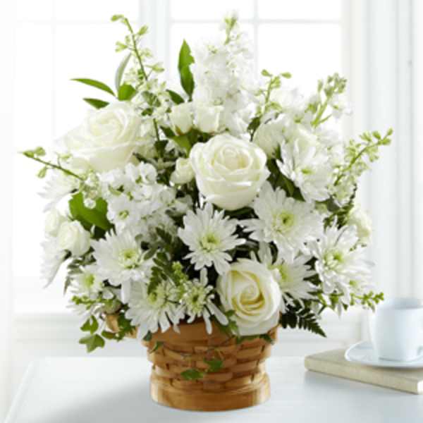 White roses and daisies in a woven basket