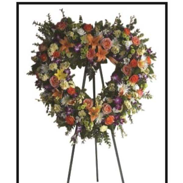 Large floral wreath on a standing easel with mixed blooms