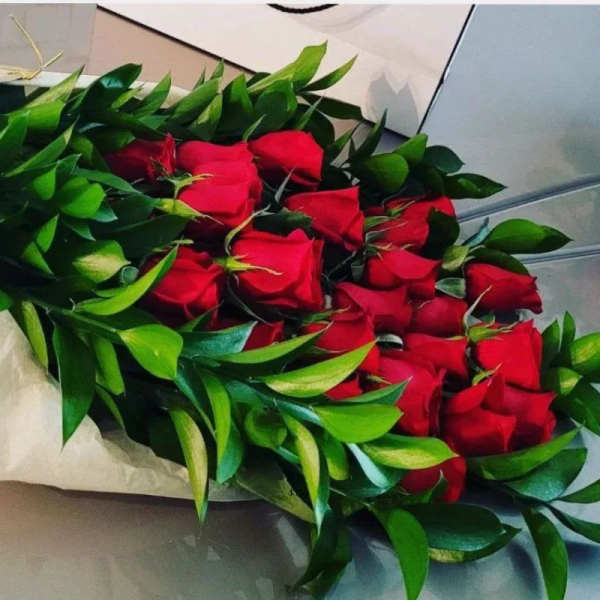 Bouquet of red roses with dense green foliage