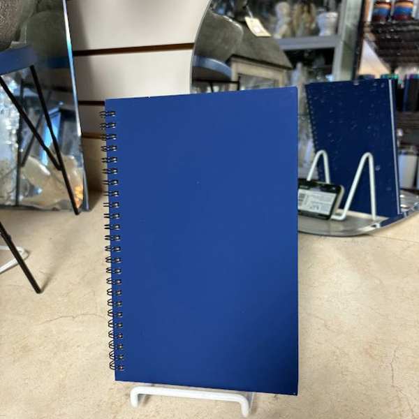 Blue spiral-bound notebook on a display stand