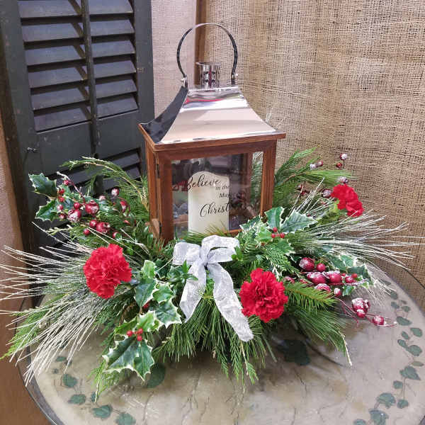 Christmas lantern centerpiece with red carnations and evergreen accents
