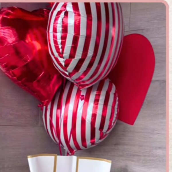 Bouquet of red and pink roses with heart-shaped balloons