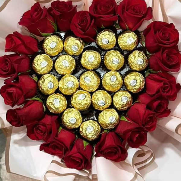 Heart-shaped bouquet of red roses with gold-wrapped chocolates