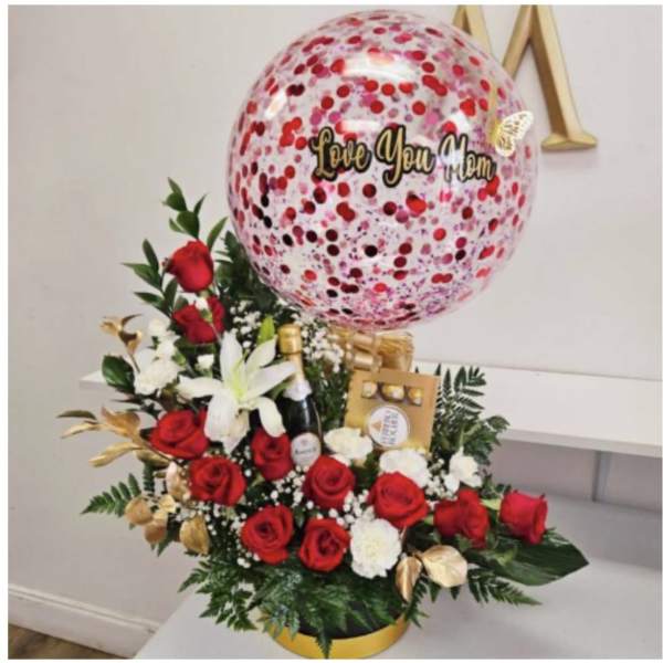 Red and white rose arrangement with a large "Love You Mom" balloon